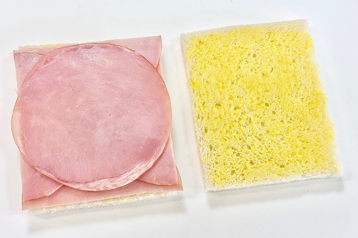 食パンにマスタードバターを塗り、チーズとハムをのせた様子